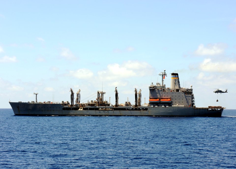 US Navy 100304-N-7088A-020 An SH-60B helicopter arries a pallet of supplies during a vertical replenishment