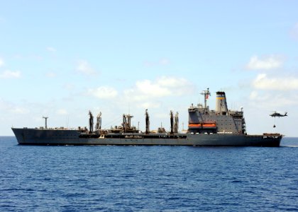 US Navy 100304-N-7088A-020 An SH-60B helicopter arries a pallet of supplies during a vertical replenishment