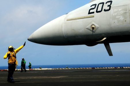 US Navy 100306-N-3038W-051 Aviation Boatswain's Mate (Handling) 1st Class Dexter Yarde directs and F-A-18E Super Hornet