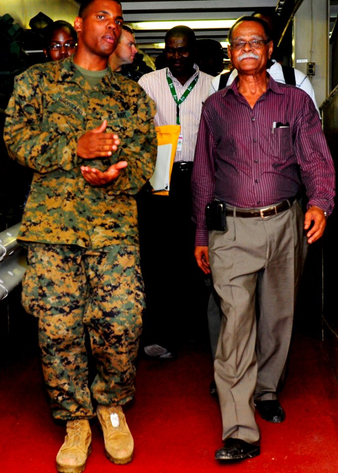 US Navy 100304-N-4378P-061 Haiti's Minister of Health, Dr. Alex Larsen, tours the Military Sealift Command hospital ship USNS Comfort (T-AH 20) with Hospital Corrpsman Christopher Brossard, a Haitian-American Sailor