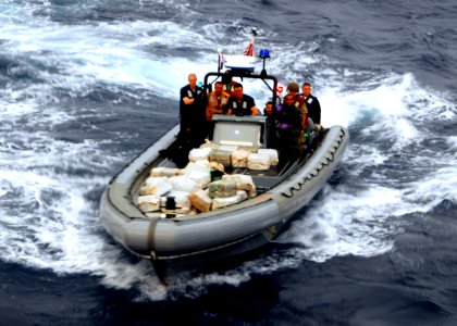 US Navy 100304-N-7058E-037 Sailors and Coast Guardsmen from USS Freedom (LCS 1) transport bales of cocaine seized from a go-fast small boat in the southern Caribbean Sea