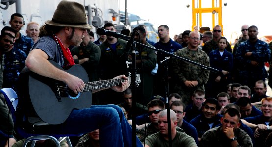 US Navy 100303-N-7508R-056 Big Kenny, a member of the country music duo Big and Rich, performs on the flight deck of the multipurpose amphibious assault ship USS Bataan (LHD 5)