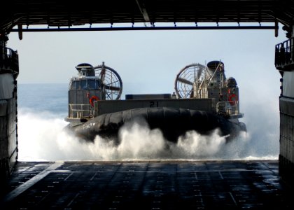 US Navy 100304-N-6692A-032 Landing Craft Air Cushion (LCAC) 21 assigned to Assault Craft Unit (ACU) 5, enters the well deck of the amphibious dock landing ship USS Harpers Ferry (LSD 49) d photo