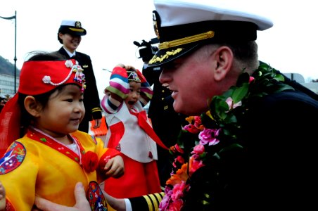 US Navy 100305-N-7478G-337 Capt. Rudy Lupton, commanding officer of the U.S. 7th Fleet command ship USS Blue Ridge (LCC 19), greets Jeon Ye Som, daughter of a Republic of Korea naval officer