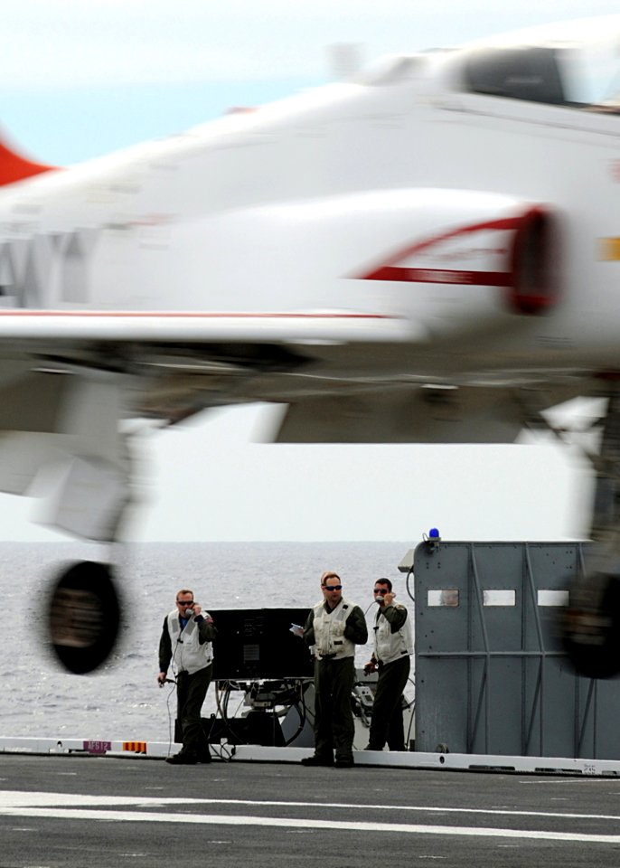 US Navy 100307-N-3885H-097 Landing signal officers observe a T-45C Goshawk training aircraft assigned to Training Wing (TRAWING) 1 land aboard the aircraft carrier USS George H.W. Bush (CVN 77)