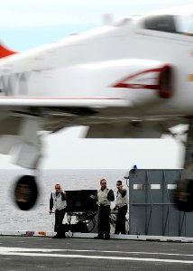 US Navy 100307-N-3885H-097 Landing signal officers observe a T-45C Goshawk training aircraft assigned to Training Wing (TRAWING) 1 land aboard the aircraft carrier USS George H.W. Bush (CVN 77)