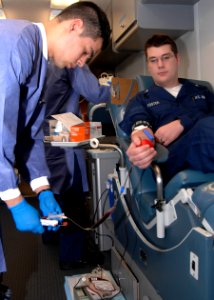 US Navy 100308-N-3705H-005 Hospital Corpsman Juan Ramirez-Alcala draws blood from Machinist's Mate 3rd Class Adam Foster during a blood drive aboard the Nimitz-class aircraft carrier USS Harry S. Truman (CVN 75)