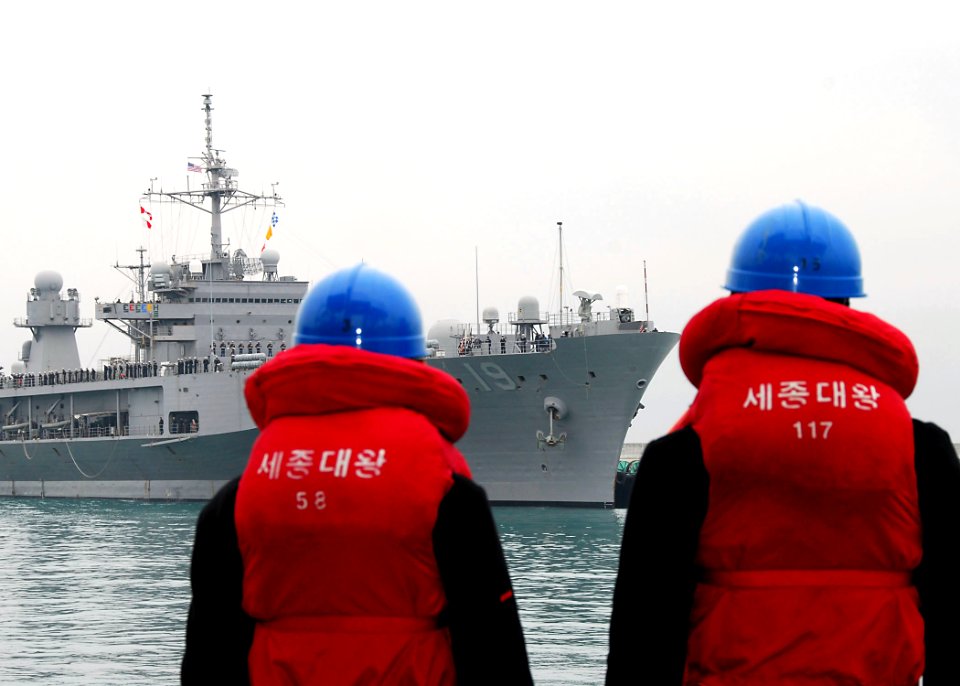US Navy 100305-N-9573A-009 Two Korean sailors watch the U.S. 7th Fleet command ship USS Blue Ridge (LCC 19) as it arrives in Busan, Republic of Korea