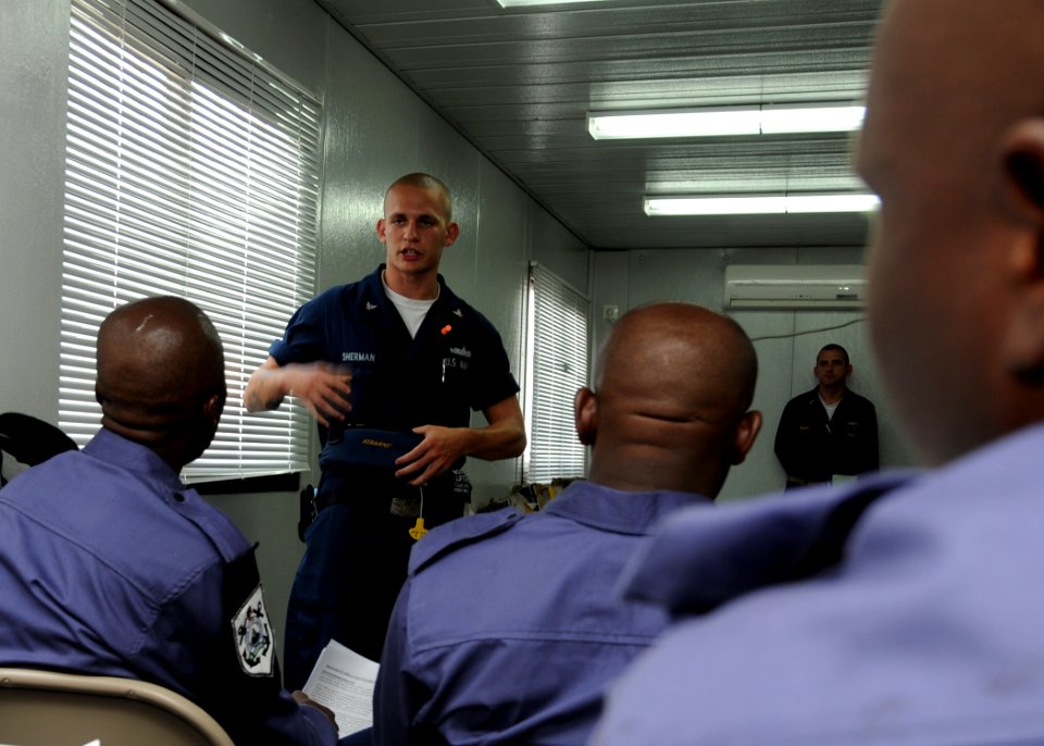 US Navy 100308-N-6676S-076 Boatswain's Mate 3rd Class Christian Sherman, from Findlay, Ohio, discusses procedures for abandoning ship with sailors from the Nigerian navy