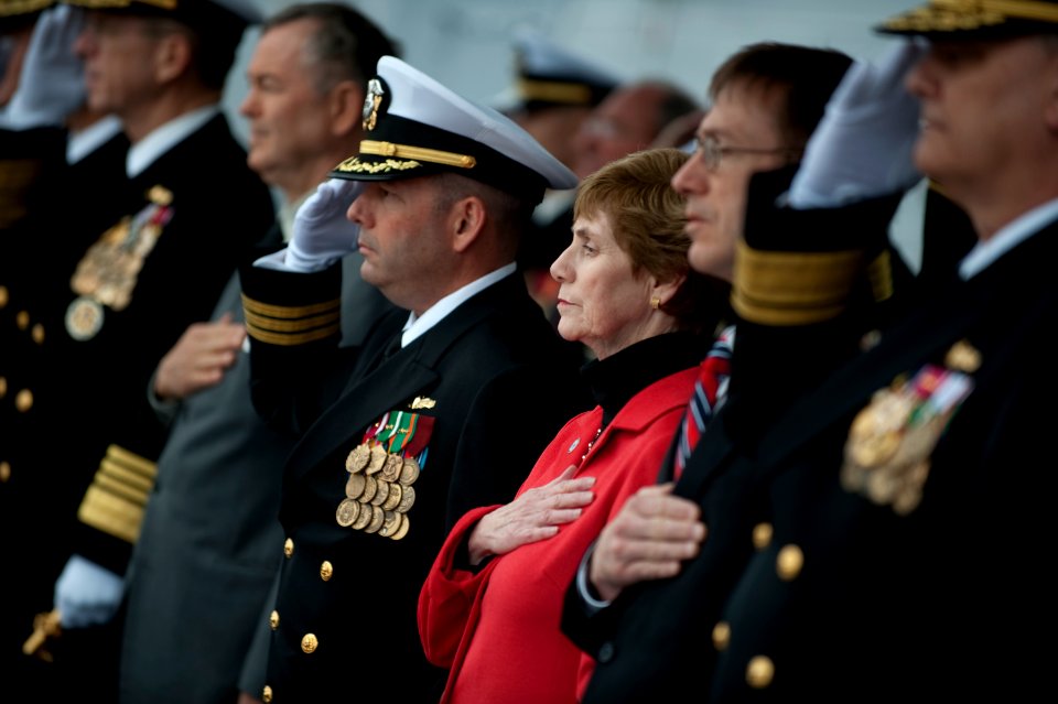US Navy 100306-N-0696M-266 Deborah Mullen, center, ship's sponsor of the Arleigh Burke-class guided-missile destroyer USS Dewey (DDG 105), renders honors with the official party