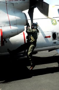 US Navy 100306-N-3038W-084 Lt. Joseph Dominguez, from Brownsville, Ore., assigned to the Providers of Carrier Logistics Support Squadron (VRC) 30, conducts a preflight inspection of a C-2A Greyhound aboard the aircraft carrier
