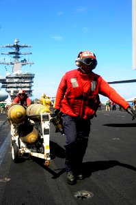 US Navy 100306-N-3038W-587 Aviation ordnancemen transport MK 83 1,000-pound general purpose bombs