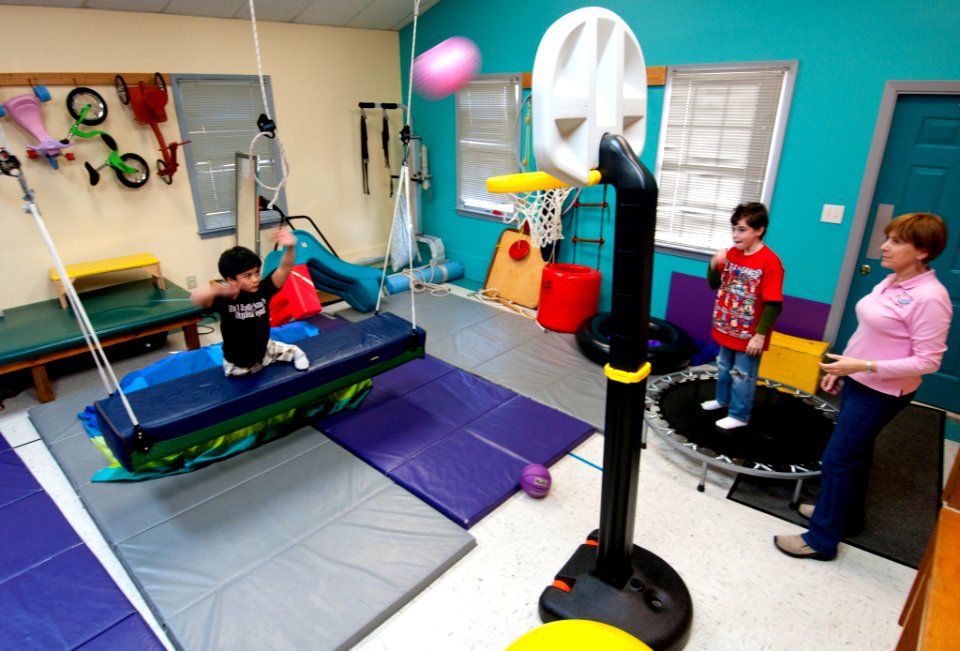 US Navy 100306-N-5319A-069 Ten-year-old Joseph Camano, left, exercises on a swing during a routine physical therapy session at the Diane Epplein ^ Assoc. Pediatric Therapy facility gymnasium while fellow patient nine-year-old L