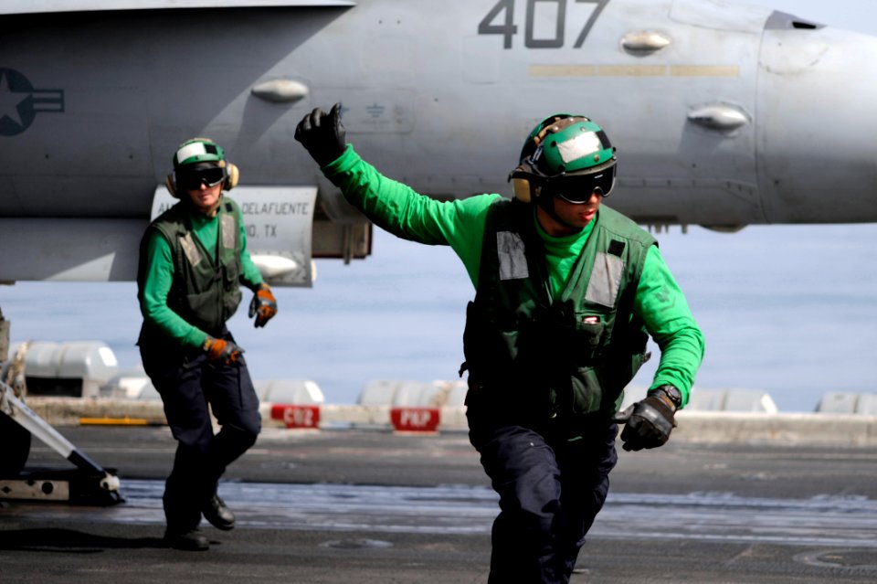 US Navy 100307-N-6604E-151 Aviation Boatswain's Mate (Equipment) 3rd Class Jullard gives a thumbs-up after checking an aircraft before it launches during flight operations aboard the Nimitz-class aircraft carrier aircraft carri
