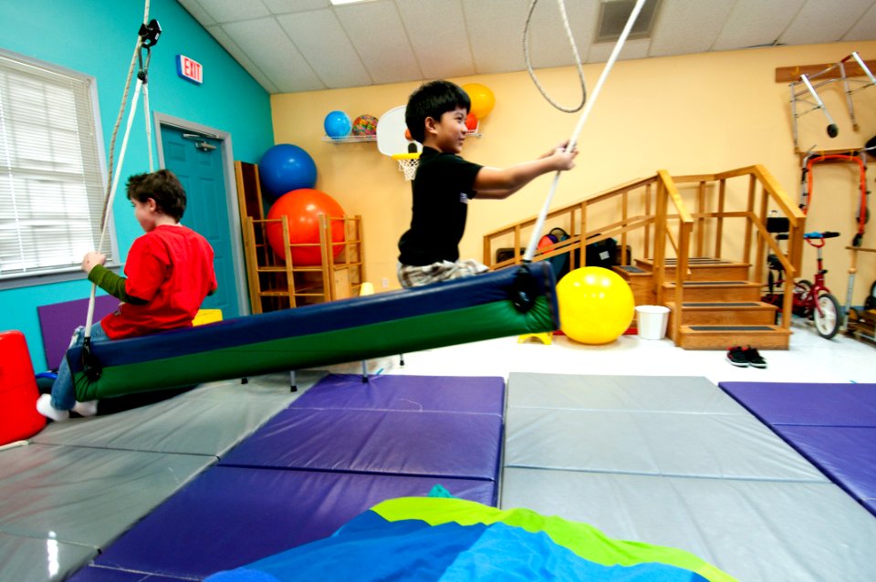 US Navy 100306-N-5319A-056 Ten-year-old Joseph Camano, right, and therapy patient nine-year-old Logan Flaathen work together to swing in the Diane Epplein ^ Assoc. Pediatric Therapy facility gymnasium during a routine physical