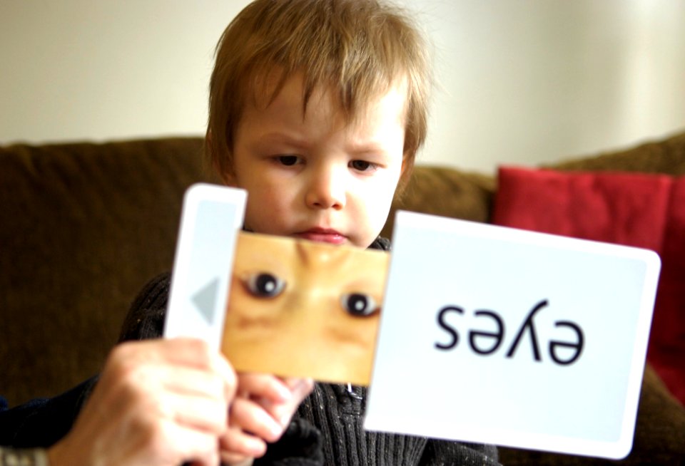 US Navy 100310-N-4178C-005 Three-year-old Joey Adams identifies items from flash cards during an in-home therapy session. Adams