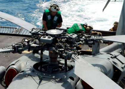 US Navy 100310-N-7058E-148 A Sailor assigned to Helicopter Sea Combat Squadron (HSC) 22 works on an MH-60S Sea Hawk helicopter aboard the littoral combat ship USS Freedom (LCS 1)