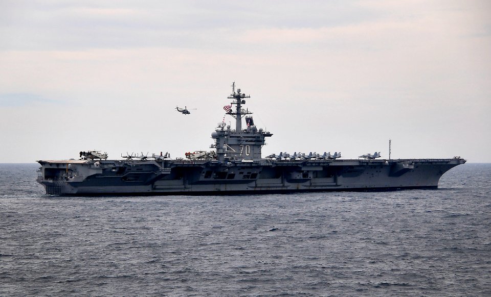US Navy 100308-N-4774B-748 A helicopter flies over the Nimitz-class aircraft carrier USS Carl Vinson (CVN 70) during Southern Seas 2010