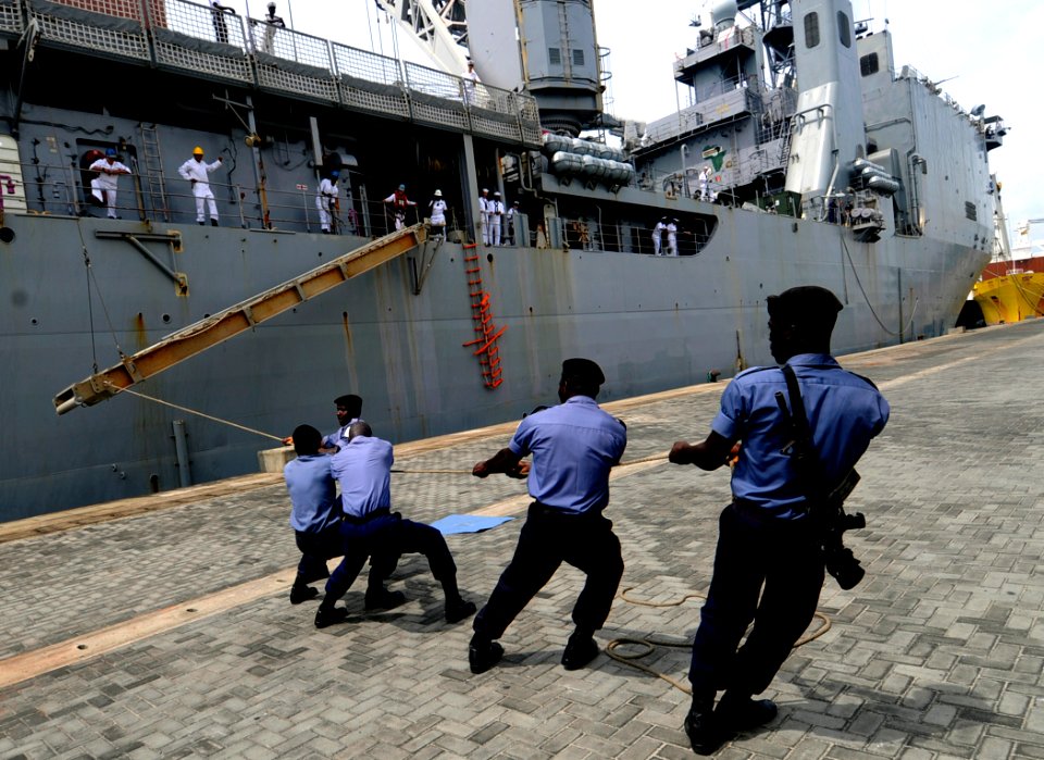 US Navy 100310-N-7948C-183 Ghana sailors work with Sailors aboard the amphibious dock landing ship USS Gunston Hall (LSD 44) to moor the ship for the first African port visit of Africa Partnership Station (APS) West 2010