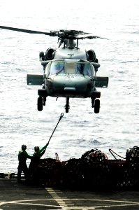 US Navy 100307-N-3038W-333 Crewmembers attach a cargo pendant to an MH-60S Sea Hawk helicopter