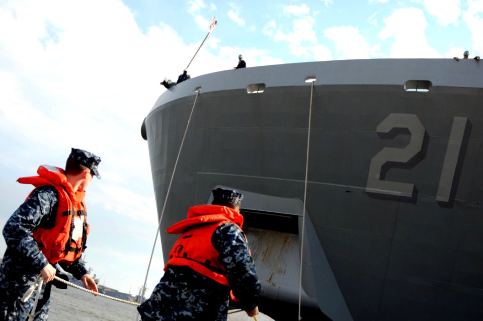 US Navy 100310-N-8590G-012 Quartermaster 3rd Class Mark Dollof and Operations Specialist Seaman Kyle Willis heave a mooring line from USS New York (LPD 21)