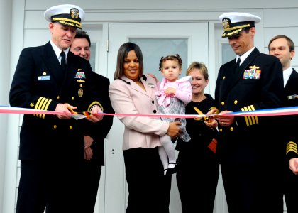 US Navy 100312-N-5087R-101 Capt. Kelly M. Johnson, left, commanding officer of Naval Station Norfolk, cuts the ribbon at the grand opening of the Child and Youth 24-7 Center at Naval Station Norfolk