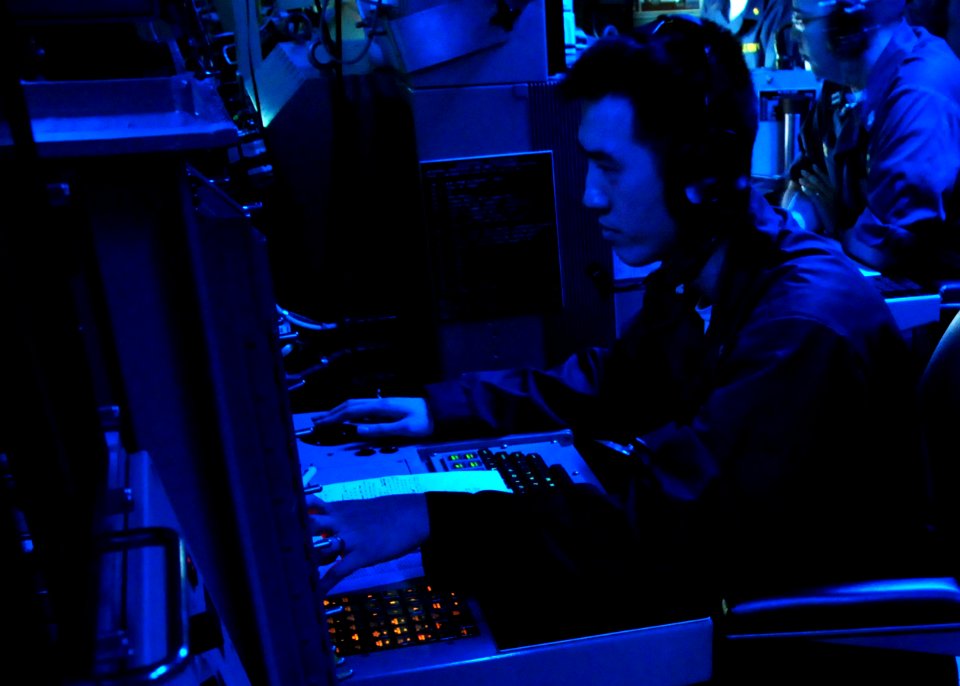 US Navy 100310-N-0120A-069 Operations Specialist 2nd Class Eric Tan monitors an air search radar during a detect-to-engage training scenario