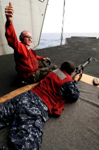 US Navy 100312-N-3038W-354 Aviation Ordnanceman Airman Justin Fezel gives a thumbs up to signal that the firing line is loaded and ready during an M-16 gun shoot