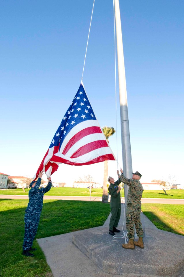 US Navy 100312-N-2728S-007 Chief Aviation Warfare Systems Operator Paul Hercl, Senior Chief Naval Aircrewman Charles Dhue and Master Gunnery Sgt. Wayne Williams raise the holiday flag at Naval Air Station Corpus Christi