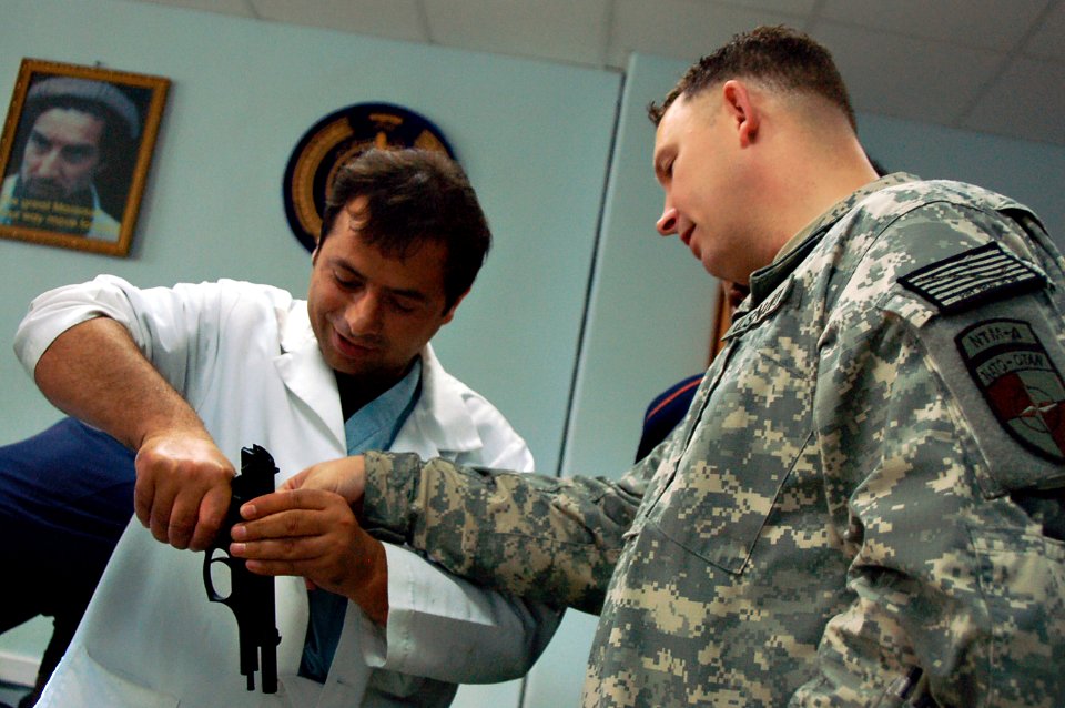 US Navy 100313-F-9200D-001 Petty Officer 1st Class Sean Buckley instructs members of the Afghan National Army 209th Corps hospital staff on weapon safety