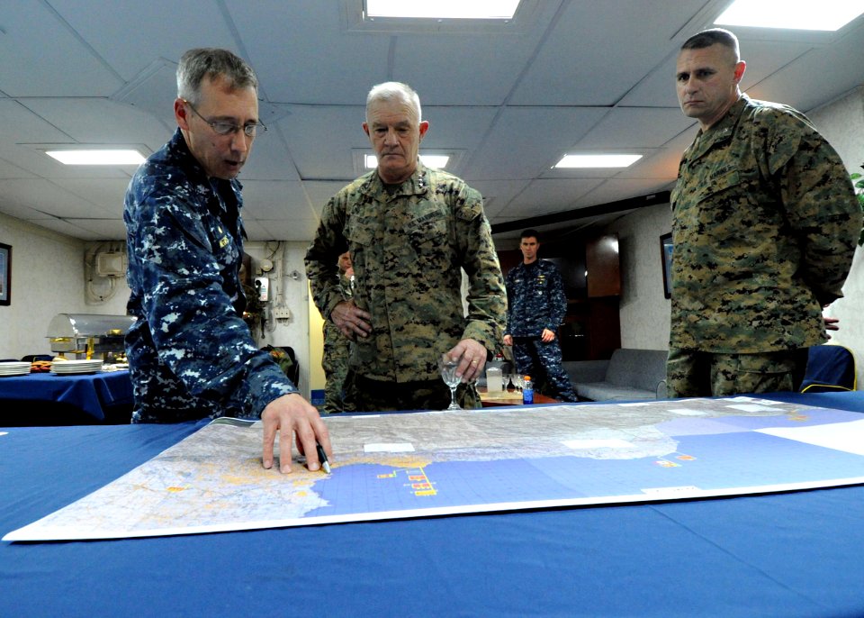 US Navy 100310-N-5961C-006 Capt. Tom Negus briefs Lt. Gen. Hejlik on the operations that the Navy and Marines have completed during Operation Unified Response