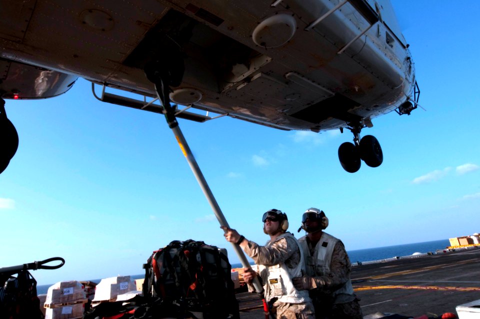 US Navy 100313-N-5712P-171 Lance Cpl. Stephen Gordon and Marine Sgt. Jarrell Williams hook supplies to a contracted SA-330J Puma helicopter