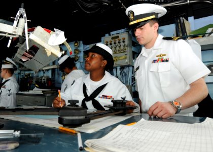 US Navy 100310-N-6676S-044 Quartermaster 2nd Class Kasey Henderson, left, Lt. j.g. Dan Ciullo plot the course for the amphibious dock landing ship USS Gunston Hall (LSD 44)