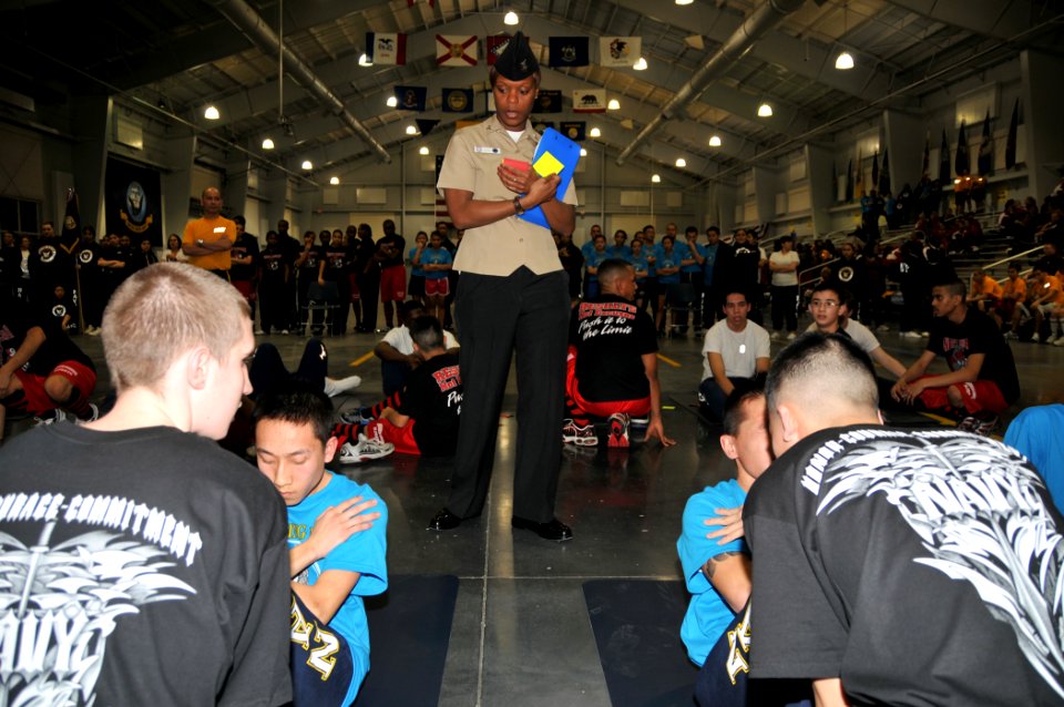 US Navy 100313-N-8848T-195 Aviation Maintenance Administrationman 2nd Class Angel Davis, center, a recruit division commander at Recruit Training Command, monitors cadets