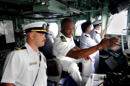 US Navy 100313-N-8335D-059 Lt. Cmdr. Walter Mainor, the commanding officer of the mine-counter measures ship USS Patriot (MCM 7,) talks with the officer of the deck