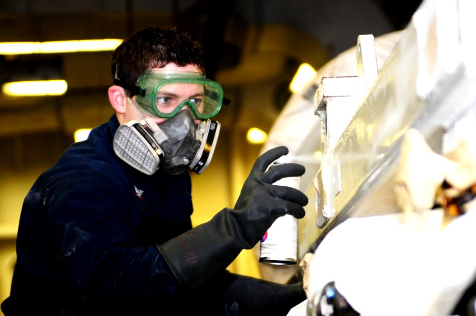 US Navy 100314-N-7939W-074 Aviation Machinist's Mate 3rd Class Phillip Skees paints a run trailer as part of corrosion control maintenance aboard USS Nimitz (CVN 68)