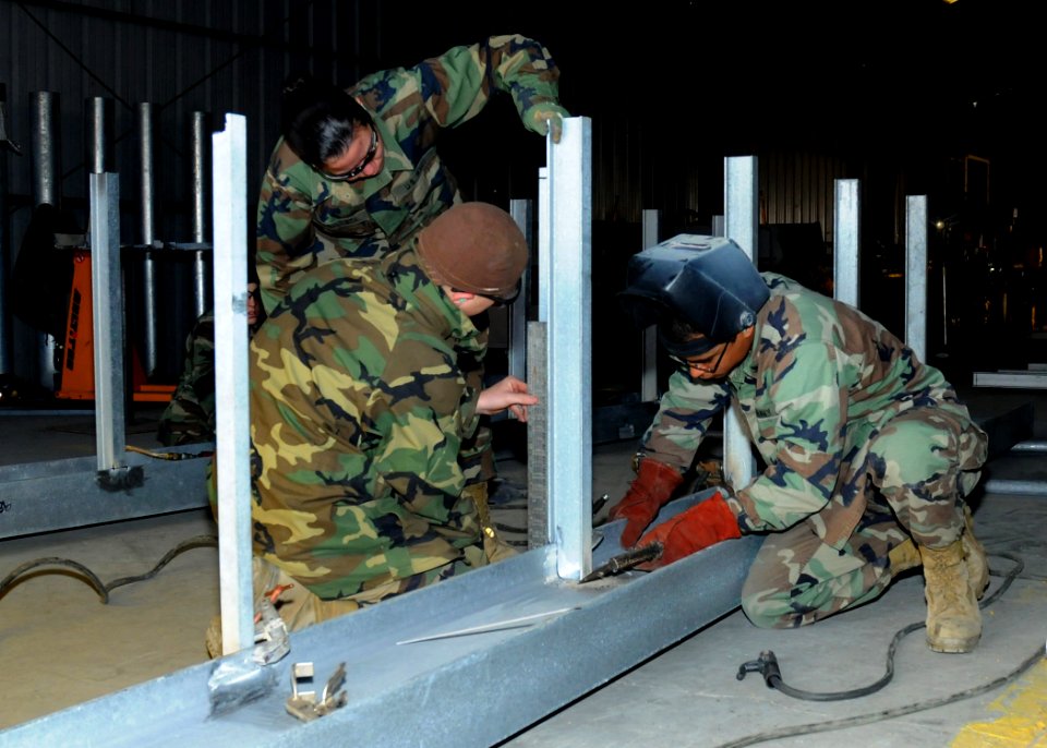 US Navy 100311-N-6357K-004 Seabees assigned to Naval Mobile Construction Battalion (NMCB) 7 assemble a fabricated maintenance catwalk at a water treatment facility at Naval Station Rota, Spain