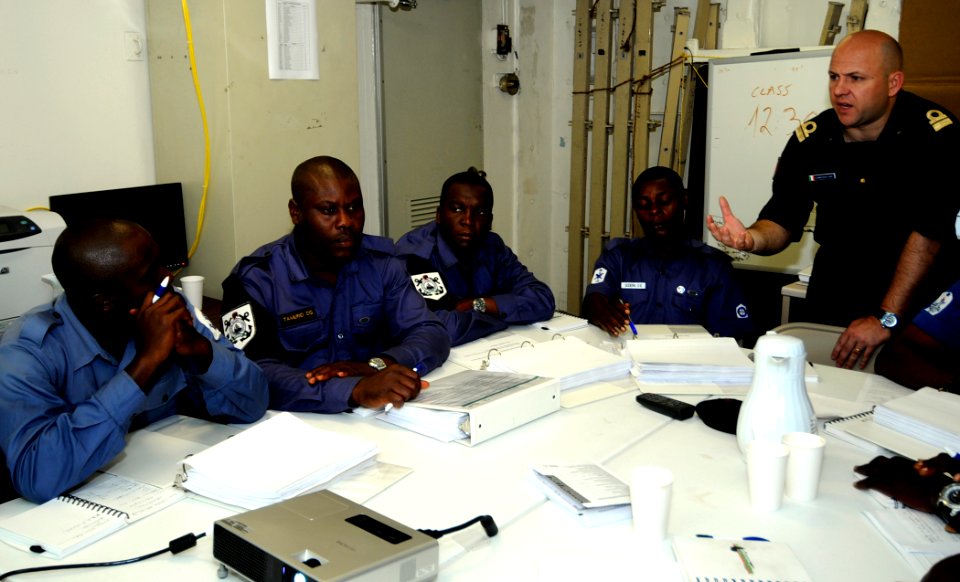 US Navy 100312-N-7948C-033 Italian navy Lt. Cmdr. Marco Compasso, assigned to Africa Partnership Station (APS) West staff, speaks with a Ghanaian Sailor during a maritime domain awareness workshop aboard the amphibious dock lan