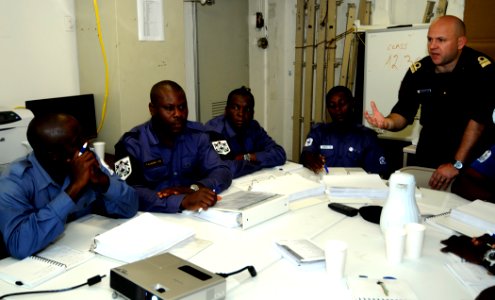 US Navy 100312-N-7948C-033 Italian navy Lt. Cmdr. Marco Compasso, assigned to Africa Partnership Station (APS) West staff, speaks with a Ghanaian Sailor during a maritime domain awareness workshop aboard the amphibious dock lan