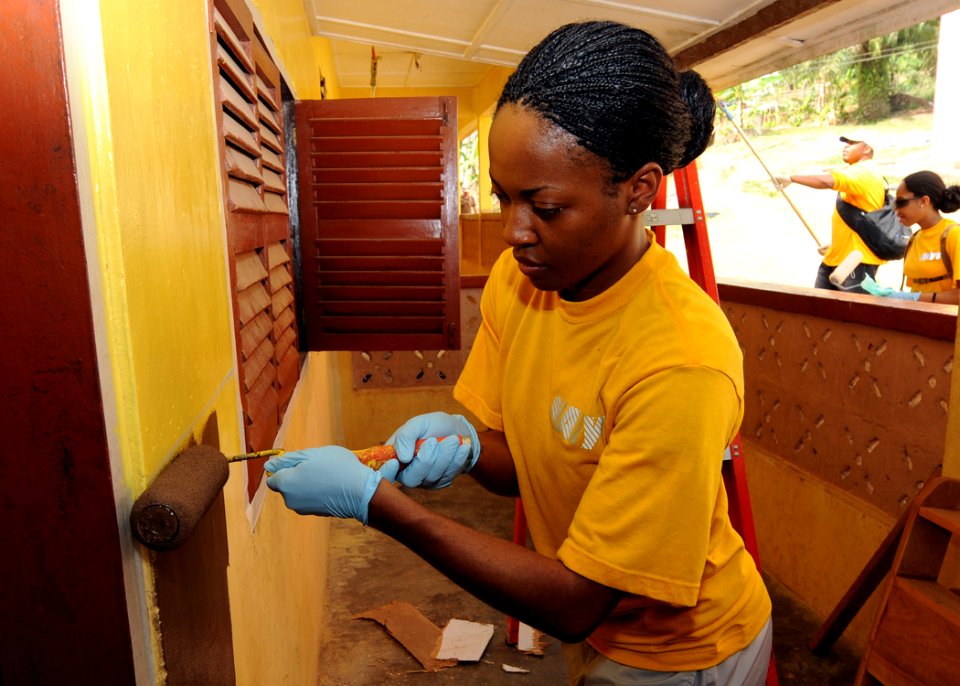 US Navy 100315-N-6676S-024 Hospital Corpsman 2nd Class Kisha Wright paints the outer wall at the Sekondi School for the Deaf