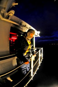 US Navy 100315-N-6006S-697 Quartermaster 3rd Class Daniel Gastaldi prepares to wash windows in the early morning hours as the aircraft carrier USS Carl Vinson (CVN 70) transits the Strait of Magellan