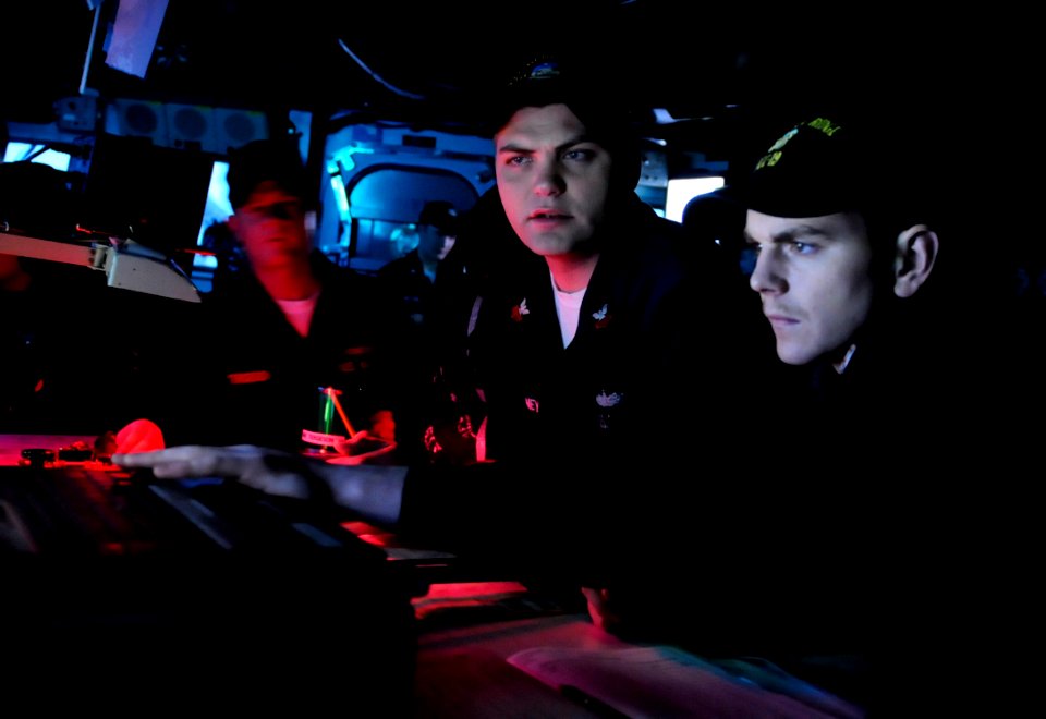 US Navy 100315-N-7478G-162 Quartermaster 1st Class Daniel Mcelvaney gives Lt. j.g. Kyle Fitzpatrick coordinates to be charted electronically. aboard USS Blue Ridge (LCC 19)