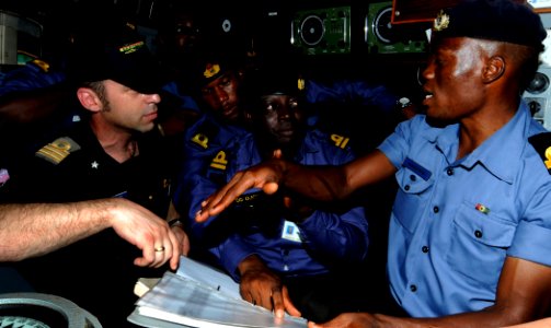 US Navy 100315-N-7948C-220 Italian navy Lt. Federico Panconi shows an example of an accurate fishing log entry to Ghanaian navy 2nd Lt. Kwadwo Ansong