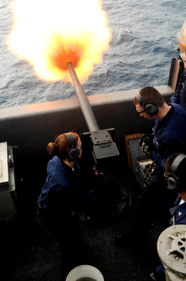 US Navy 100312-N-3038W-053 Aviation Ordnanceman Airman Recruit Chanda Axton fires a salute battery during a live fire exercise
