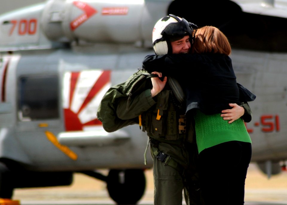 US Navy 100317-N-4031K-050 Cmdr. Steven McKone hugs his wife after his final flight as a Warlord on aircraft 700 at the squadron's flightline