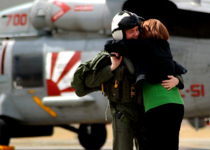 US Navy 100317-N-4031K-050 Cmdr. Steven McKone hugs his wife after his final flight as a Warlord on aircraft 700 at the squadron's flightline