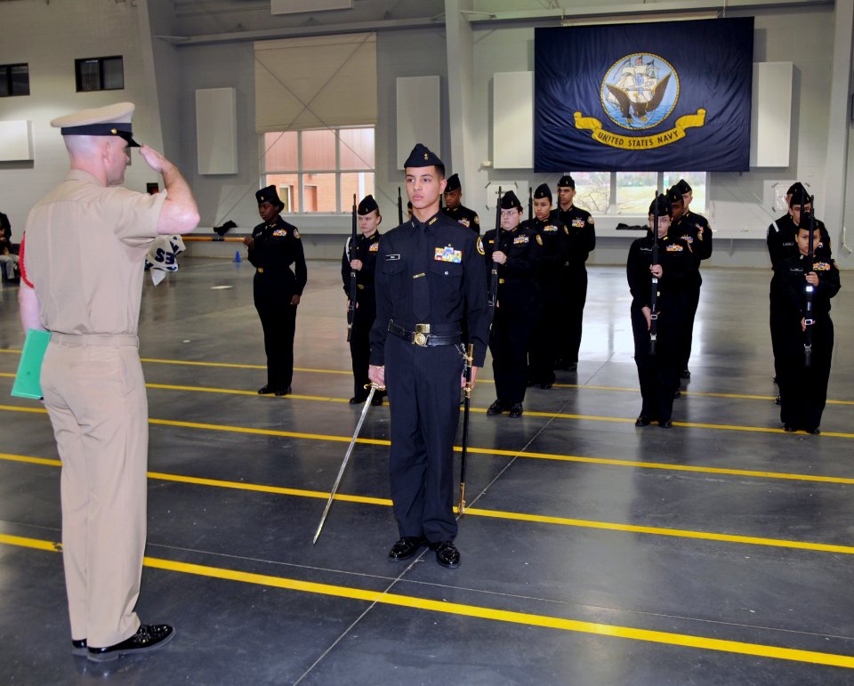 US Navy 100313-N-8848T-481 Chief Fire Controlman Robert Church salutes Navy Junior ROTC Cadet Seaman Kenny Pena, 15, a sophomore and drill commander from James Ford Rhodes High School in Cleveland, Ohio