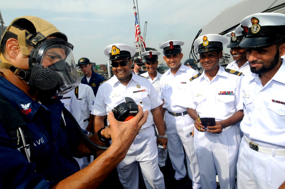 US Navy 100313-N-8335D-673 Damage Controlman 1st Class Arturo Chavez shows Bangladesh Navy sailors how to use the second-stage regulator of a self-contained breathing apparatus