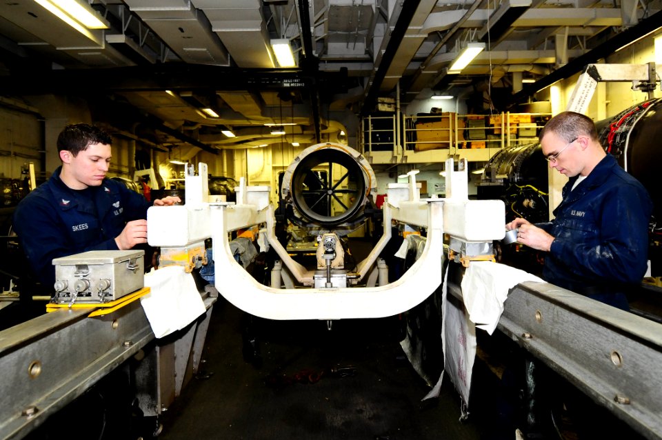 US Navy 100314-N-7939W-023 Aviation Machinist's Mate 3rd Class Phillip Skees and Aviation Machinist's Mate Seaman Chistopher Aaron prepare a run trailer for painting