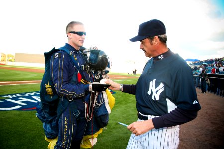 US Navy 100318-N-3271W-116 Special Warfare Operator 1st Class Isaiah Maring (SEAL) presents the game ball to New York Yankees coach Ron Guidry before a pre-season game with the Tampa Bay Rays at Steinbrenner Field photo